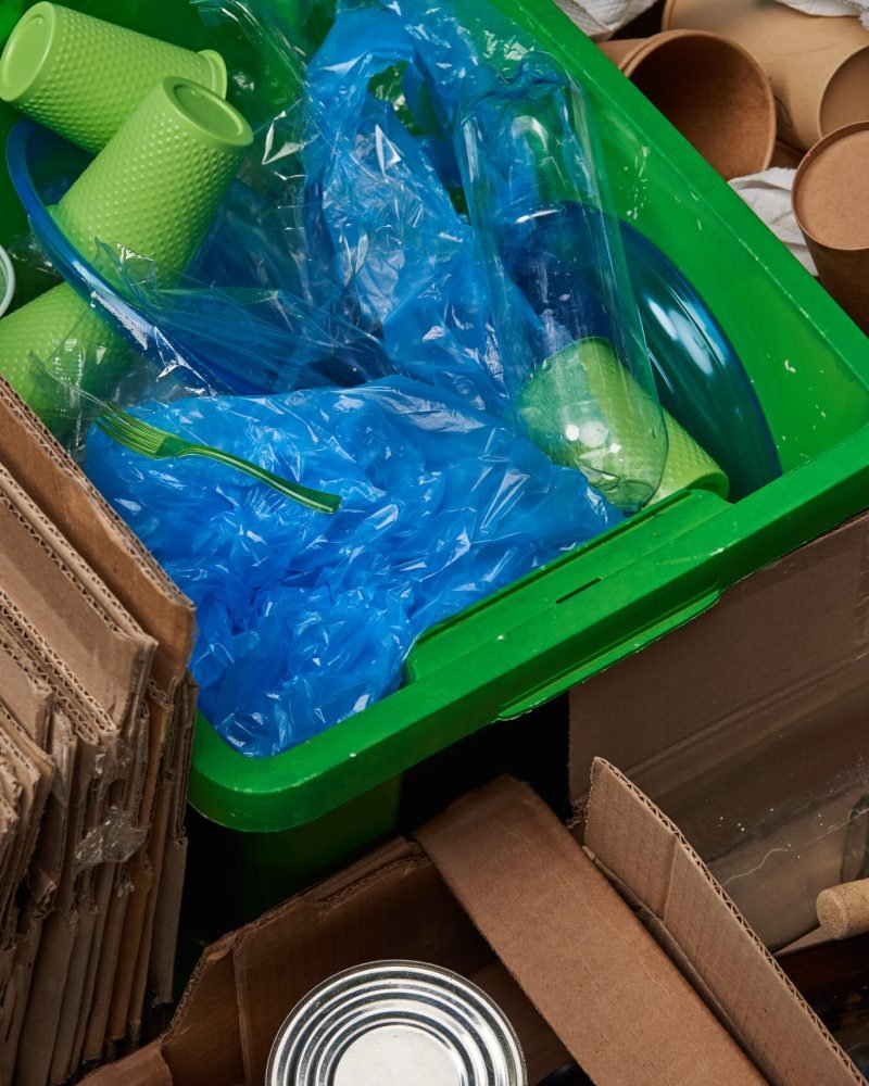 sorted trash of cardboard, glass bottles, polyethylene, plastic and paper cups